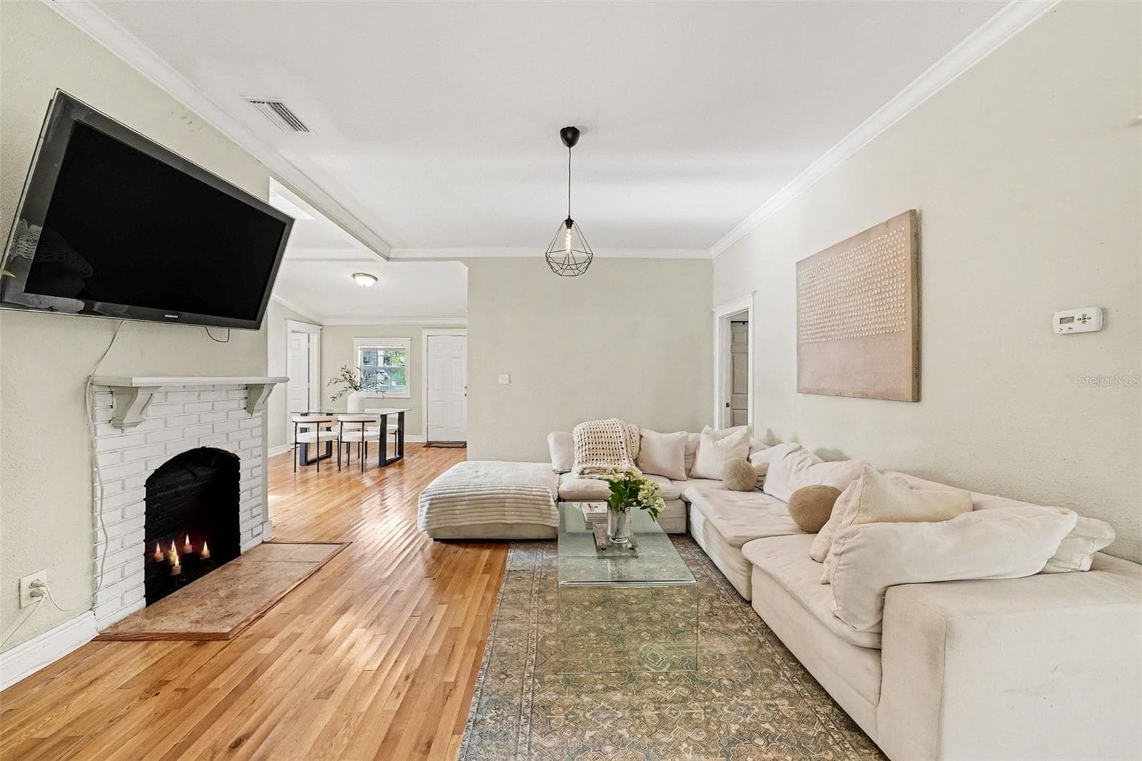 Main living area with wood flooring and open layout. - 805 E CHELSEA ST, TAMPA