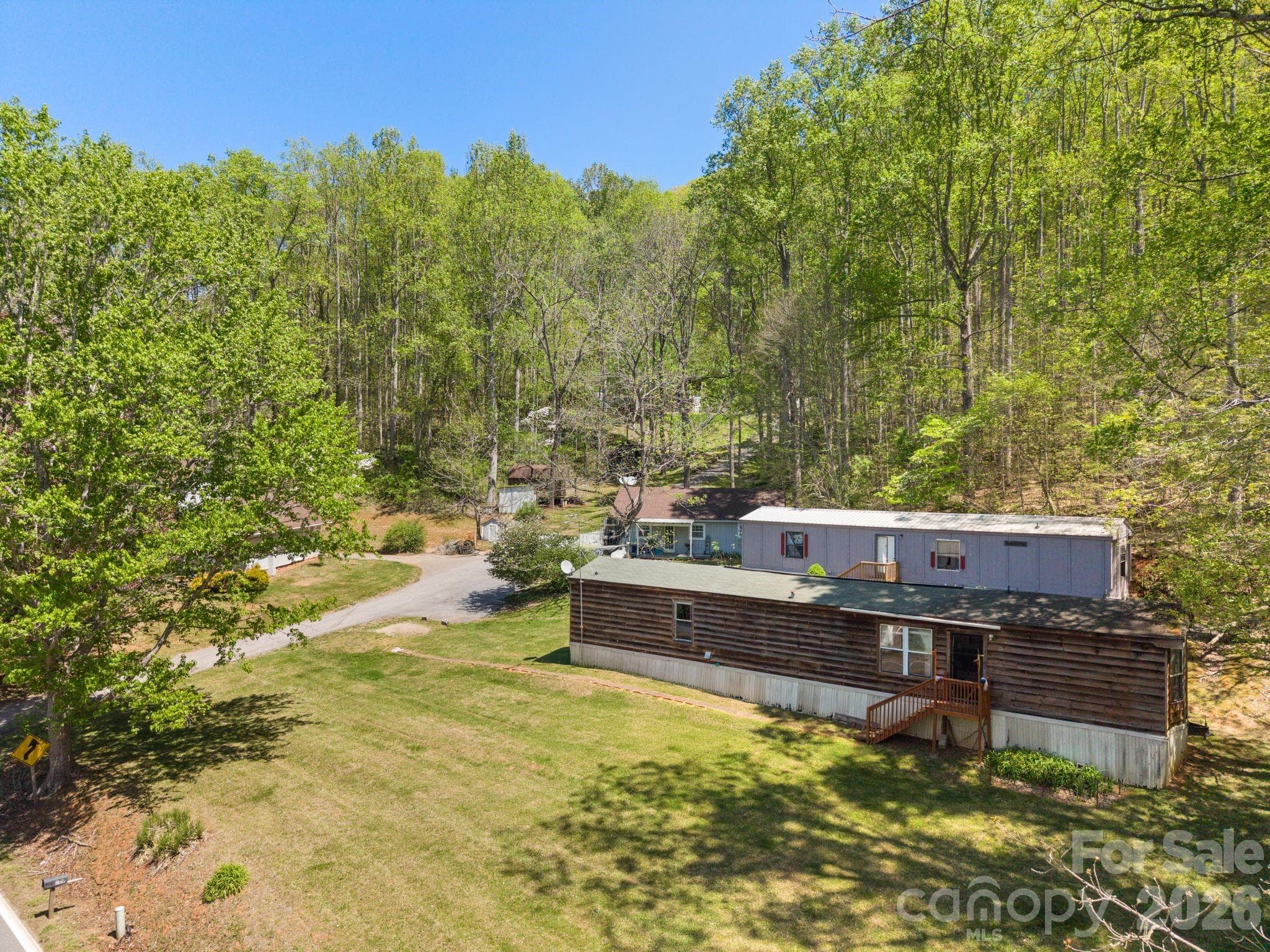 2 manufactured homes sit on the lower parcel with the 2 site built homes - 290 Hookers Gap Road, Candler