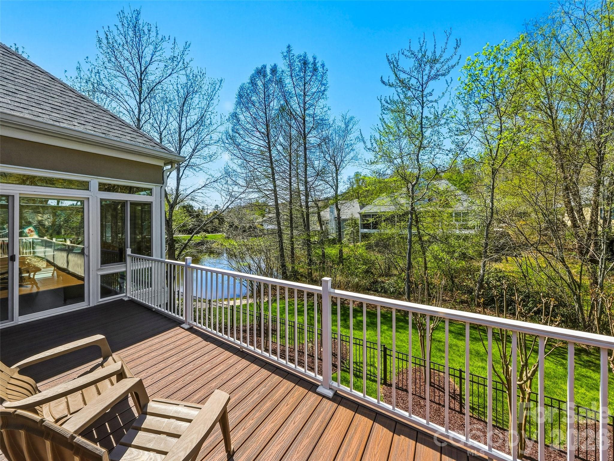 In addition to the enclosed porch, a spacious deck runs the length of the home with plenty of room for entertaining and sunbathing. - 33 Tiverton Lane, Asheville
