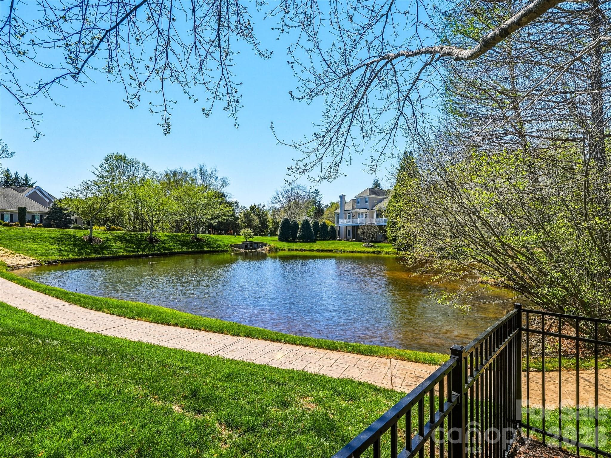 The neighborhood's pond is just beyond the fenced backyard, providing a lovely view. - 33 Tiverton Lane, Asheville