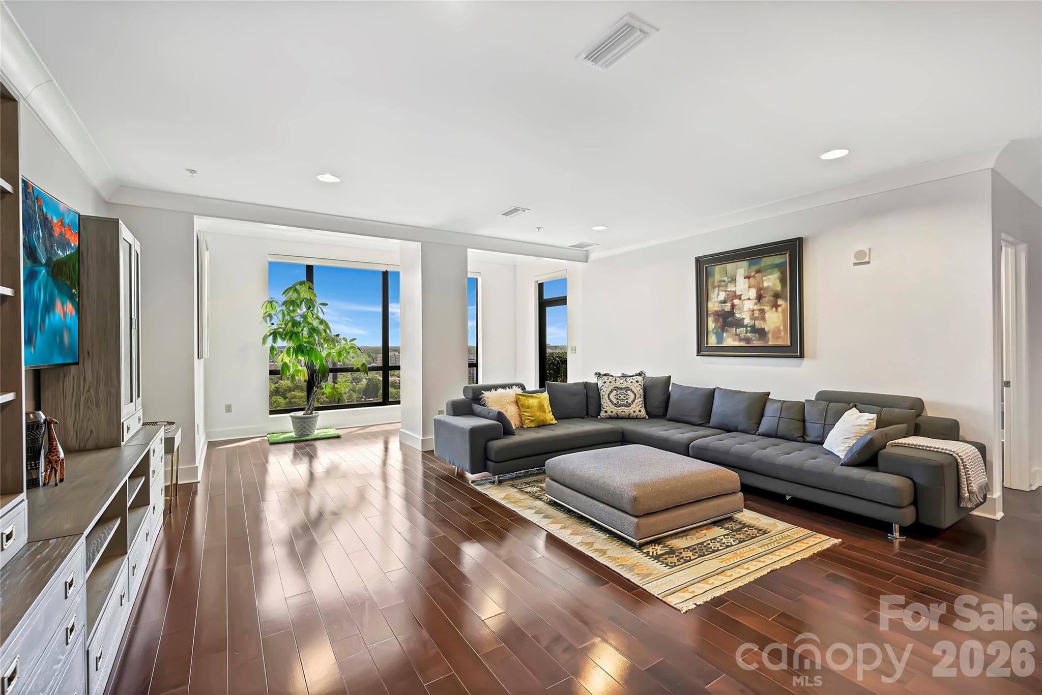Open concept design with floor-to-ceiling glass and city views. - 222 S Caldwell Street, Charlotte