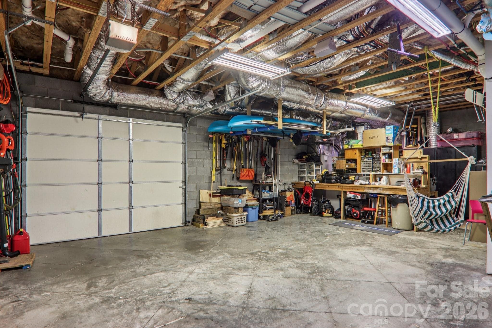 Basement workshop with garage door - 6 Wagon Trace, Flat Rock