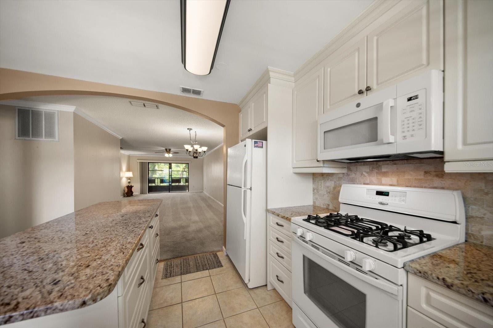 Island has lot of drawers for storage and great view to the living room and out to the porch - 5970 80TH ST N #411, ST PETERSBURG