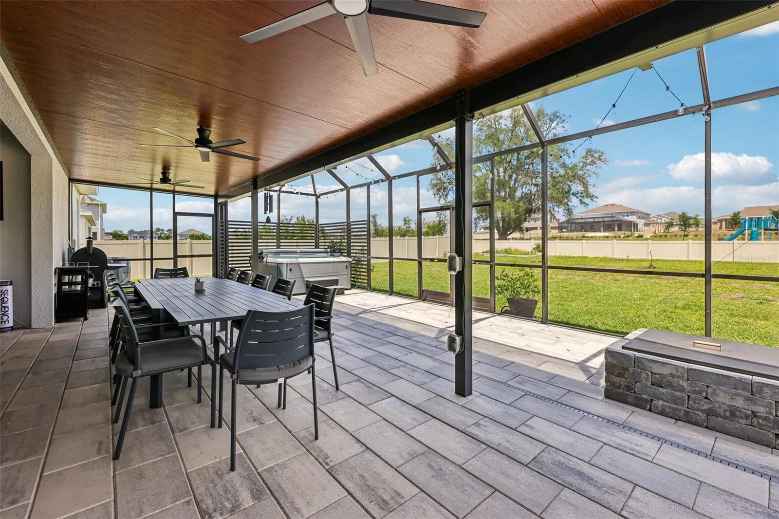 The extended lanai complete with a hot tub and firepit is an entertainers dream, overlooking an expansive fenced yard! - 6100 SIERRA CROWN ST, MOUNT DORA