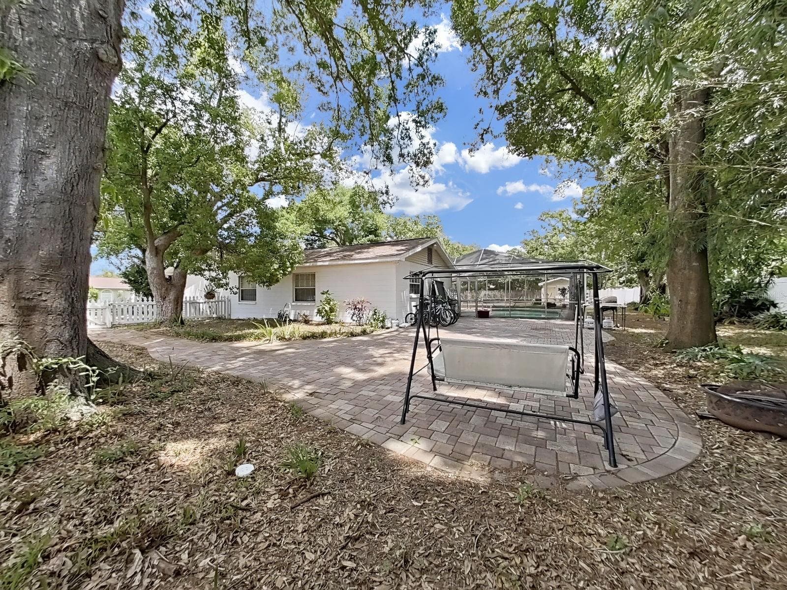 lovely brick paver patio in the west rear side of the property - 7608 BARRY RD, TAMPA