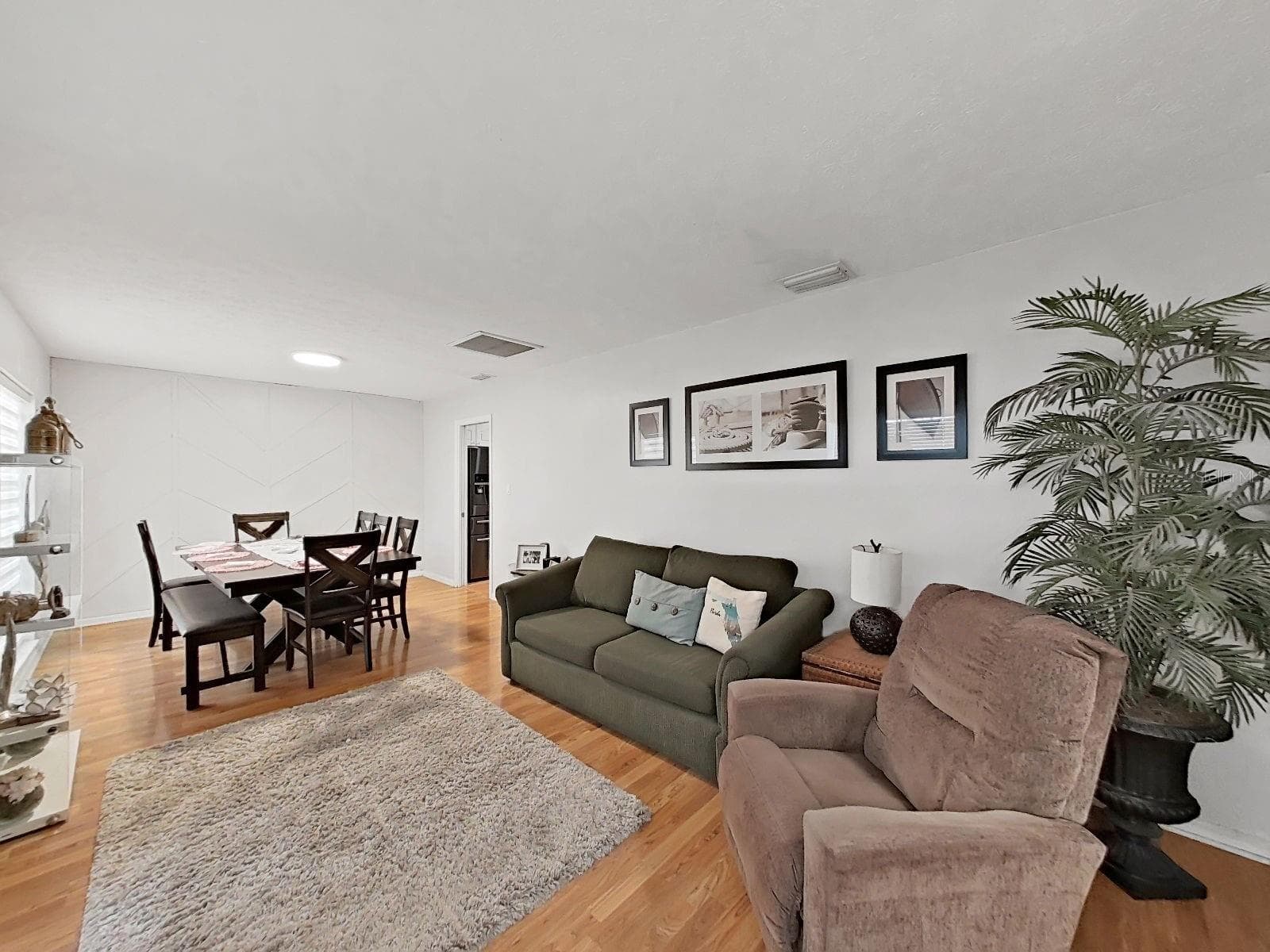 another view of living and dining rooms, doorway to kitchen in the back right - 7608 BARRY RD, TAMPA