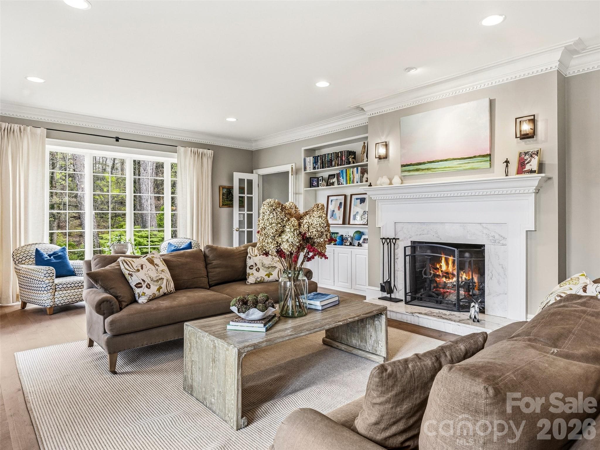 Spacious front living room with built-ins, original windows, and wood burning fireplace. This room opens out to the front terrace. - Hendersonville