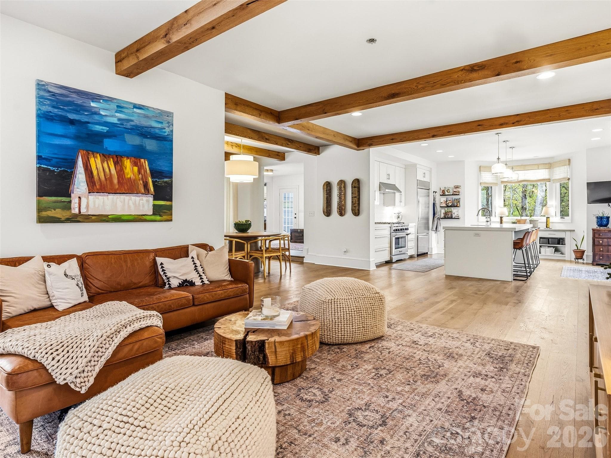 Open concept kitchen and living area with white oak flooring and beams. - 10 Kalimar Heights, Hendersonville