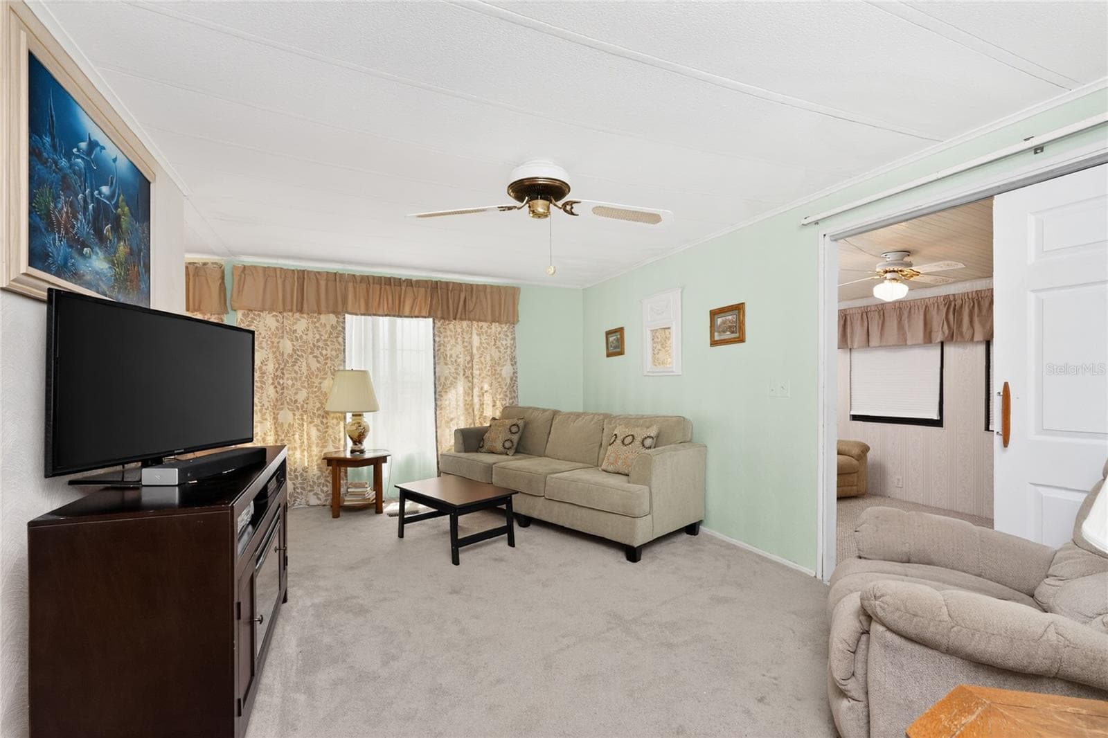 Living room features carpeted flooring and ceiling fan - 1380 SEAGULL DR, ENGLEWOOD