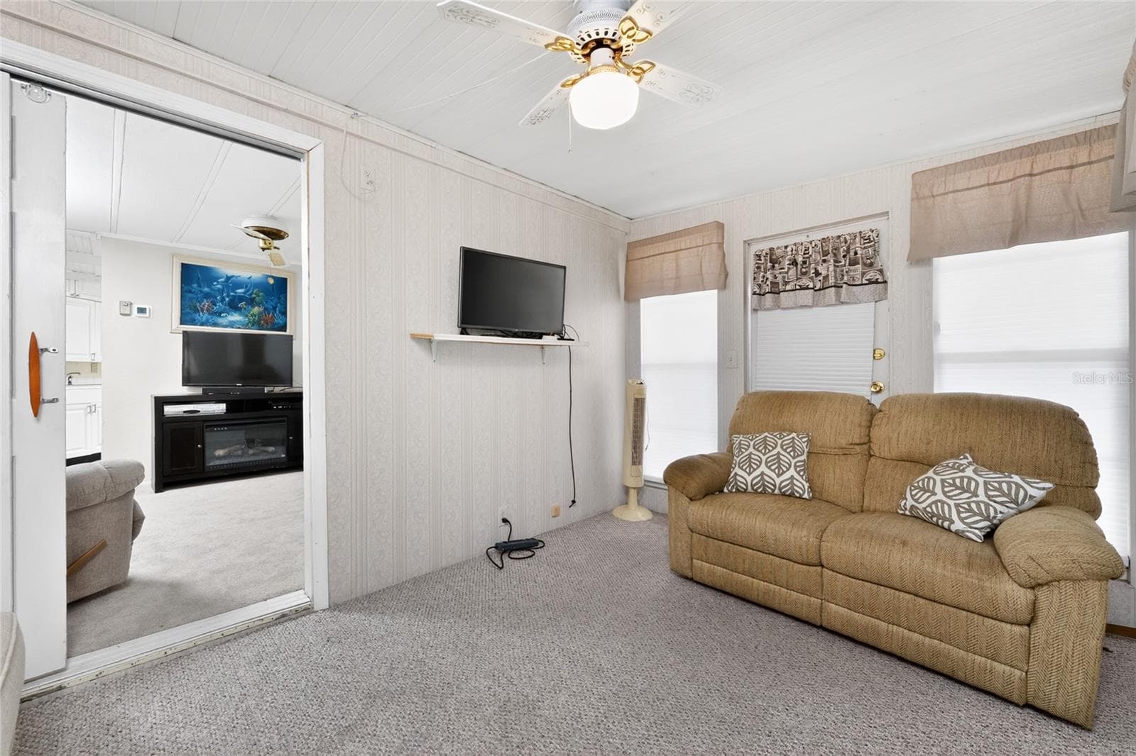 Florida room makes a great place to kick back and watch your favorite game! - 1380 SEAGULL DR, ENGLEWOOD