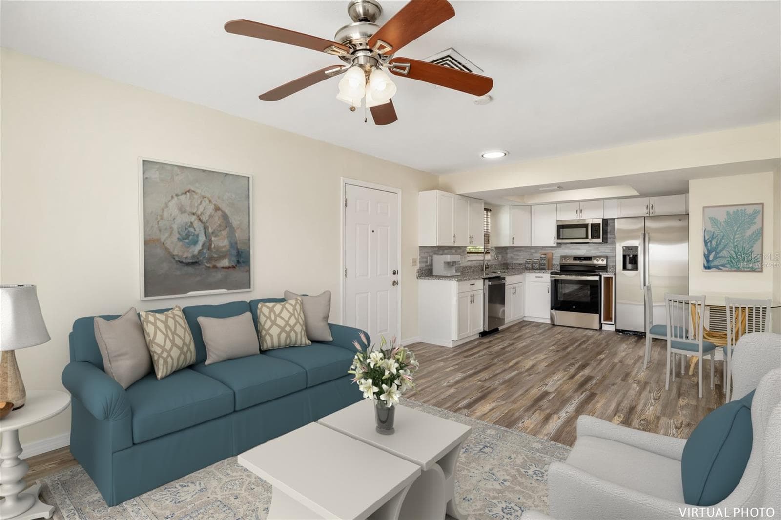 Virtually Staged Living RoomLight-filled living area with open layout and seamless flow into the kitchen and dining space. - 2513 AVENUE B #B, BRADENTON BEACH