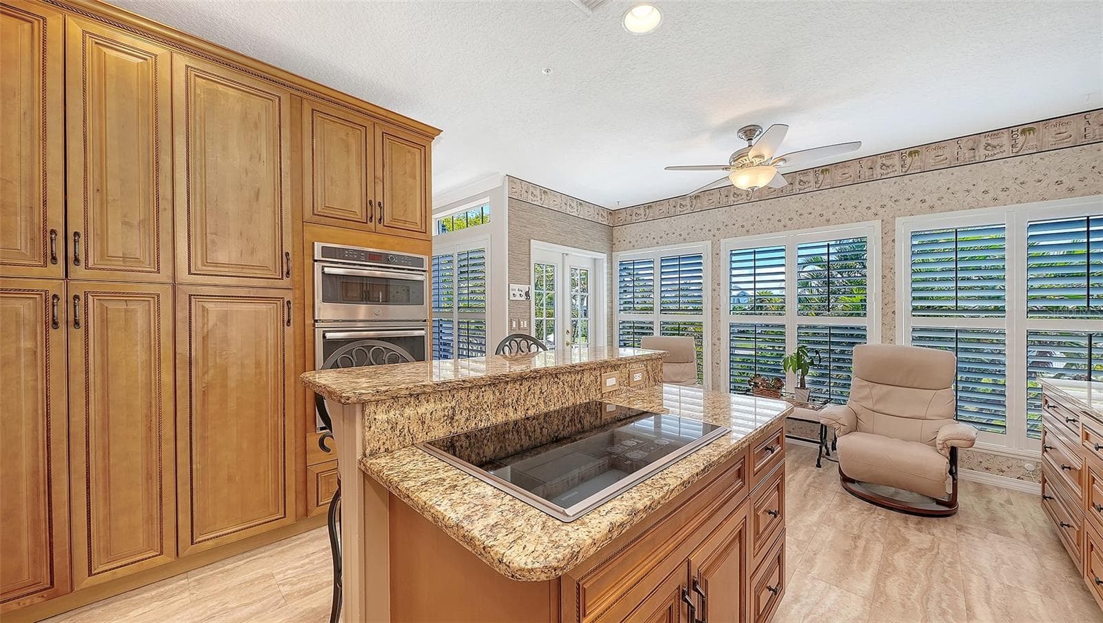 Perfect chef's kitchen with a breakfast bar, featuring all Stainless appliance package and loads of storage including a pantry wall plus built in microwave/wall oven combination and induction range! - 3040 GULF OF MEXICO DR #3, LONGBOAT KEY