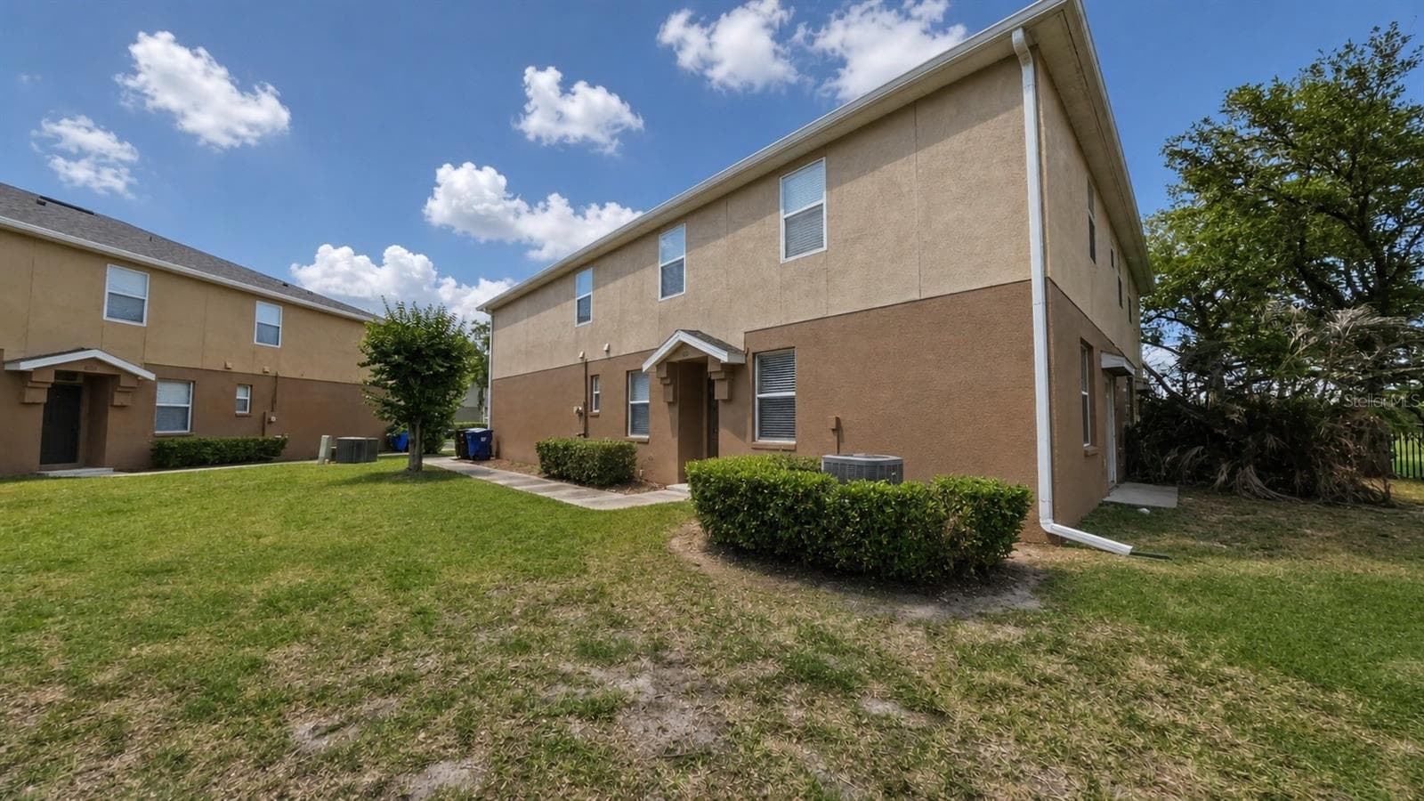 Lots of green space between this building and the next with an nice pond view in the back - 4116 ORANGE TREE CT, ST CLOUD