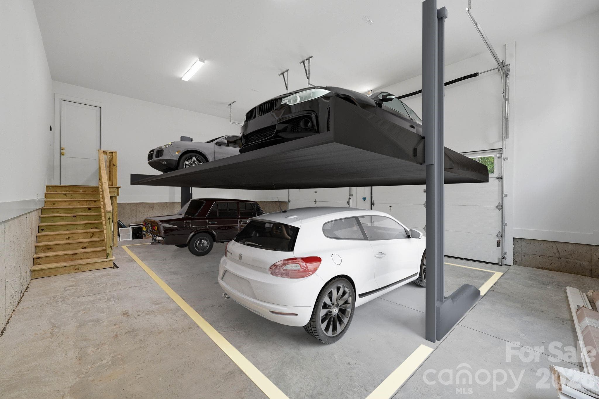 Garage staged with 4-point lifts - 539 Mammoth Oaks Drive, Charlotte