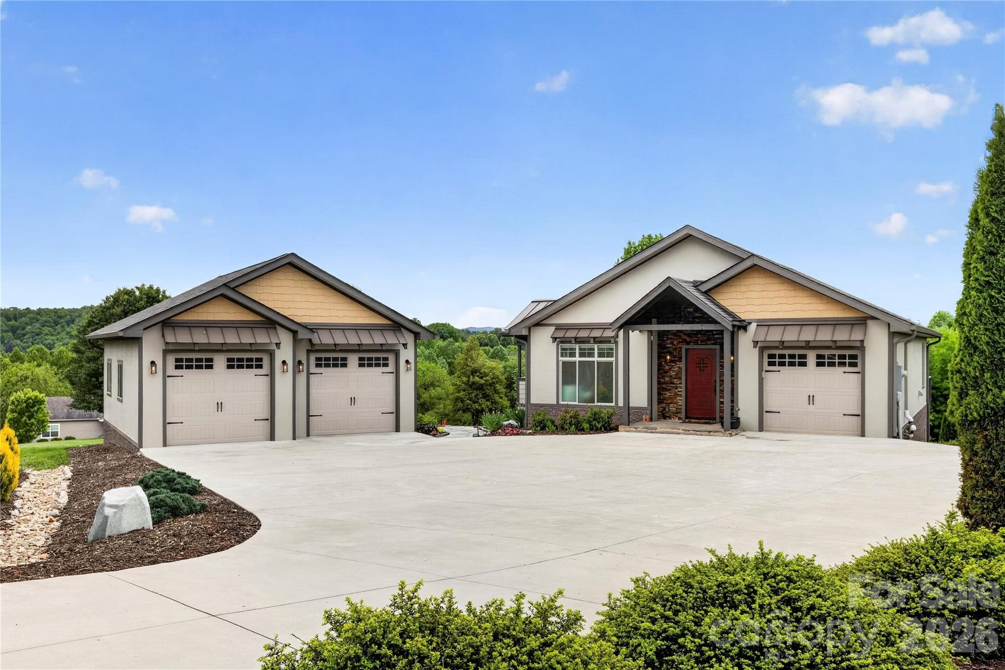 An exceptional detached 2-car garage elevates the property, featuring a car lift, professionally finished floors, and climate-controlled space—ideal for collectors, hobbyists, or workshop enthusiasts. - 141 Round Top Circle, Mills River