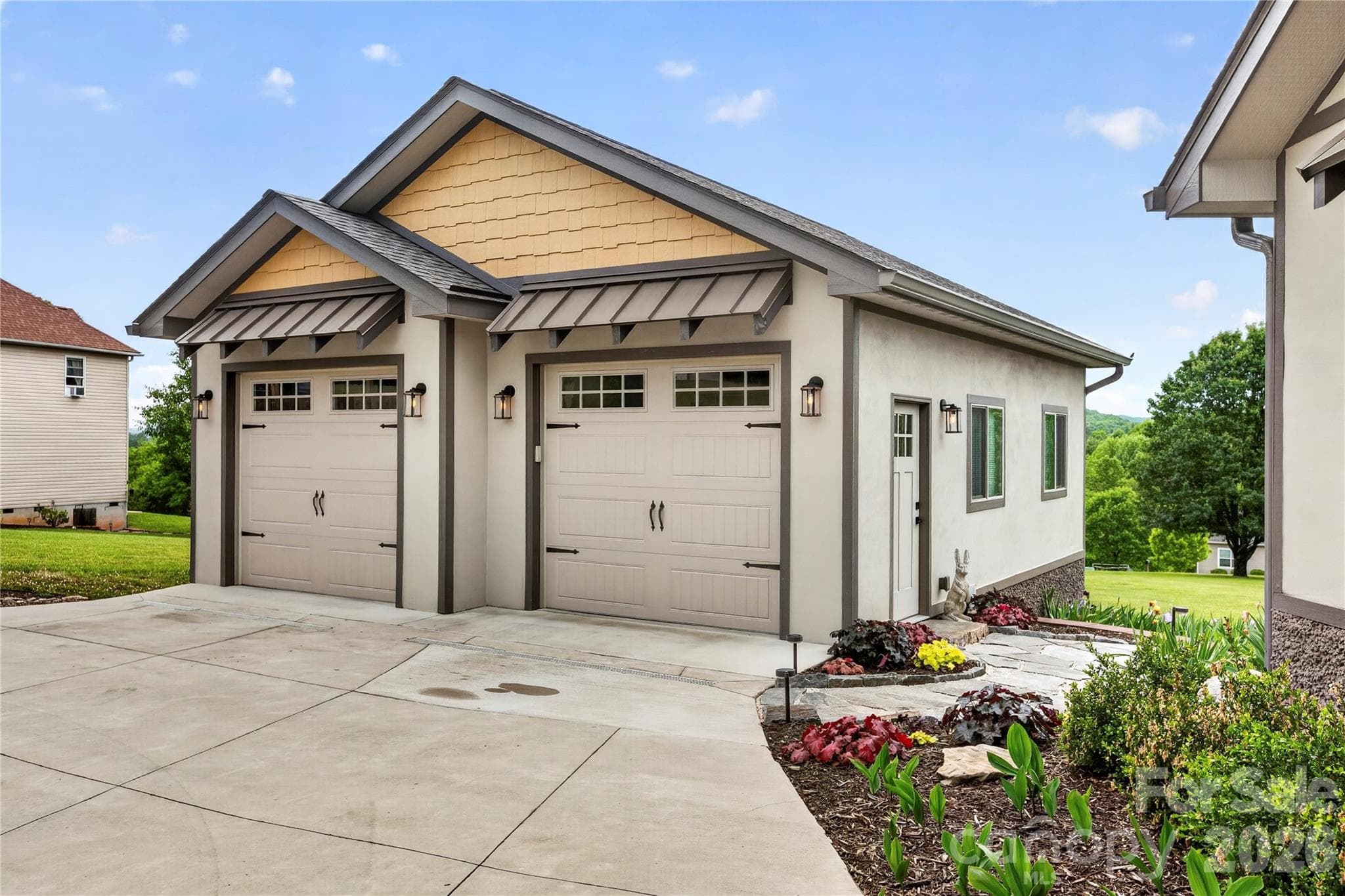 Detached 2-car garage thoughtfully designed to match the home, with no detail left undone. - 141 Round Top Circle, Mills River
