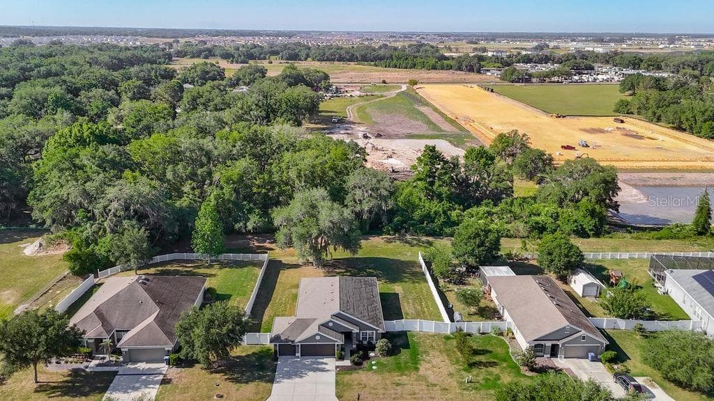 Aerial perspective showcasing the property's expansive nearly half-acre lot - 12244 LOOPBACK DR, SAN ANTONIO
