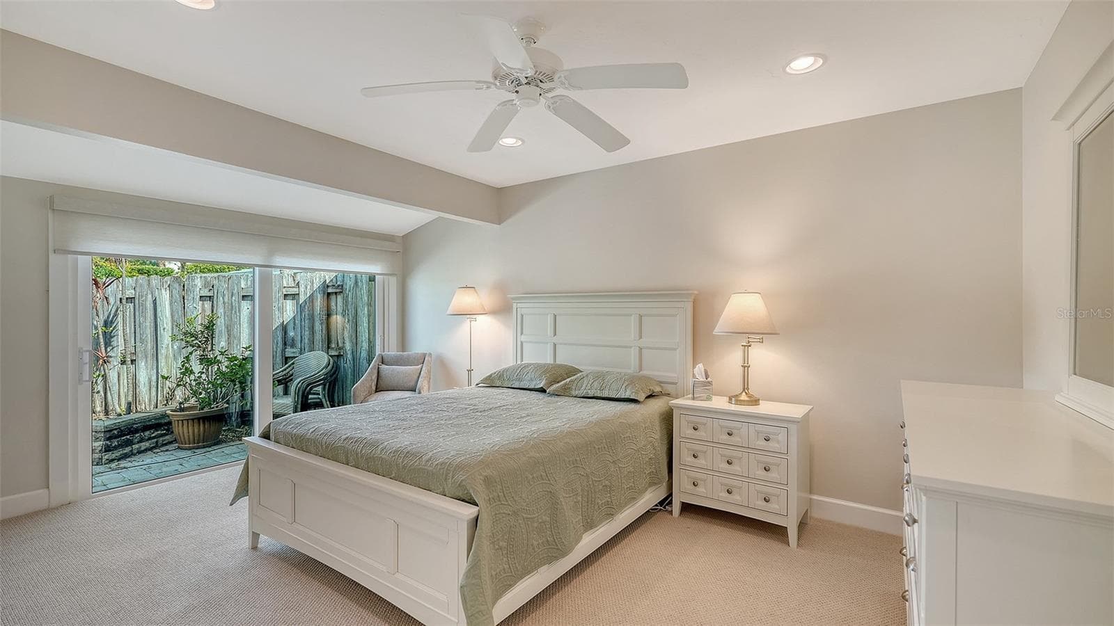 Guest bedroom with floor to ceiling sliders opening to the patio. - 206 HOURGLASS WAY #V10, SARASOTA
