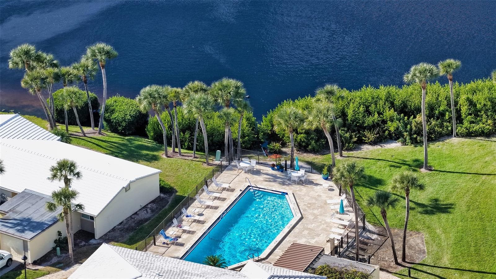 Aerial view of the clubhouse pool on the lagoon. Just steps from the villa. - 206 HOURGLASS WAY #V10, SARASOTA