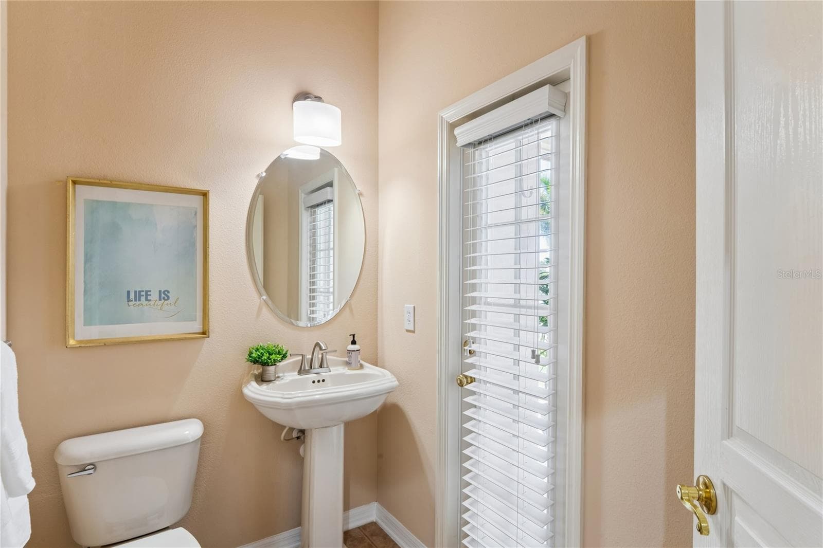Powder Bath off of lanai and just outside of Primary Bedroom for easy access - 5714 SEA TROUT PL, APOLLO BEACH