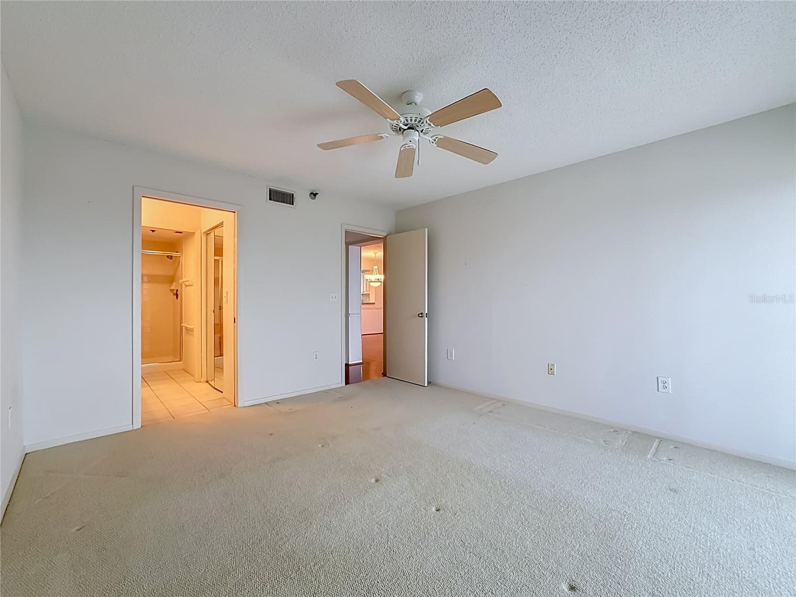 Primary bedroom with large walk-in closet and shower. - 3740 PINEBROOK CIR #607, BRADENTON