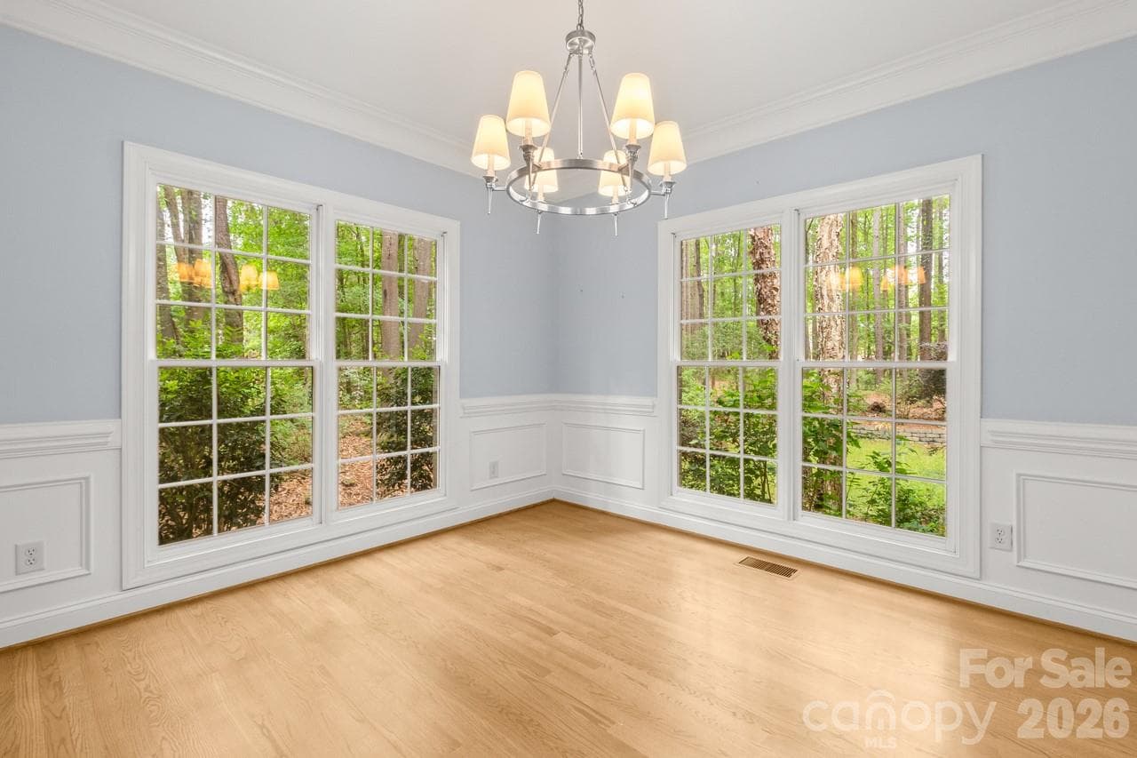 Dining room also enjoys wood flooring and lovely view through the sizable windows. - 4415 Everclear Court, Charlotte