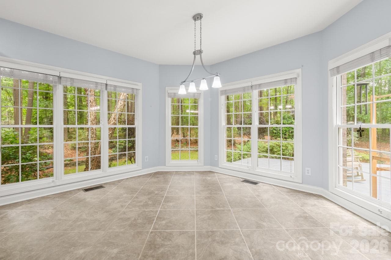 Sunny breakfast area features terrific views of the backyard. - 4415 Everclear Court, Charlotte