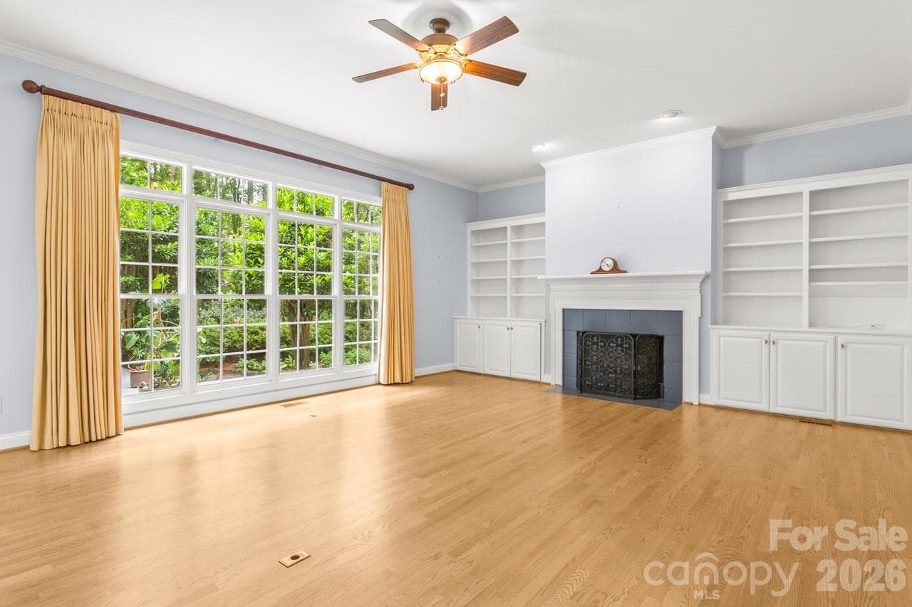 The family room boasts accessible built-ins and a gas fireplace. - 4415 Everclear Court, Charlotte