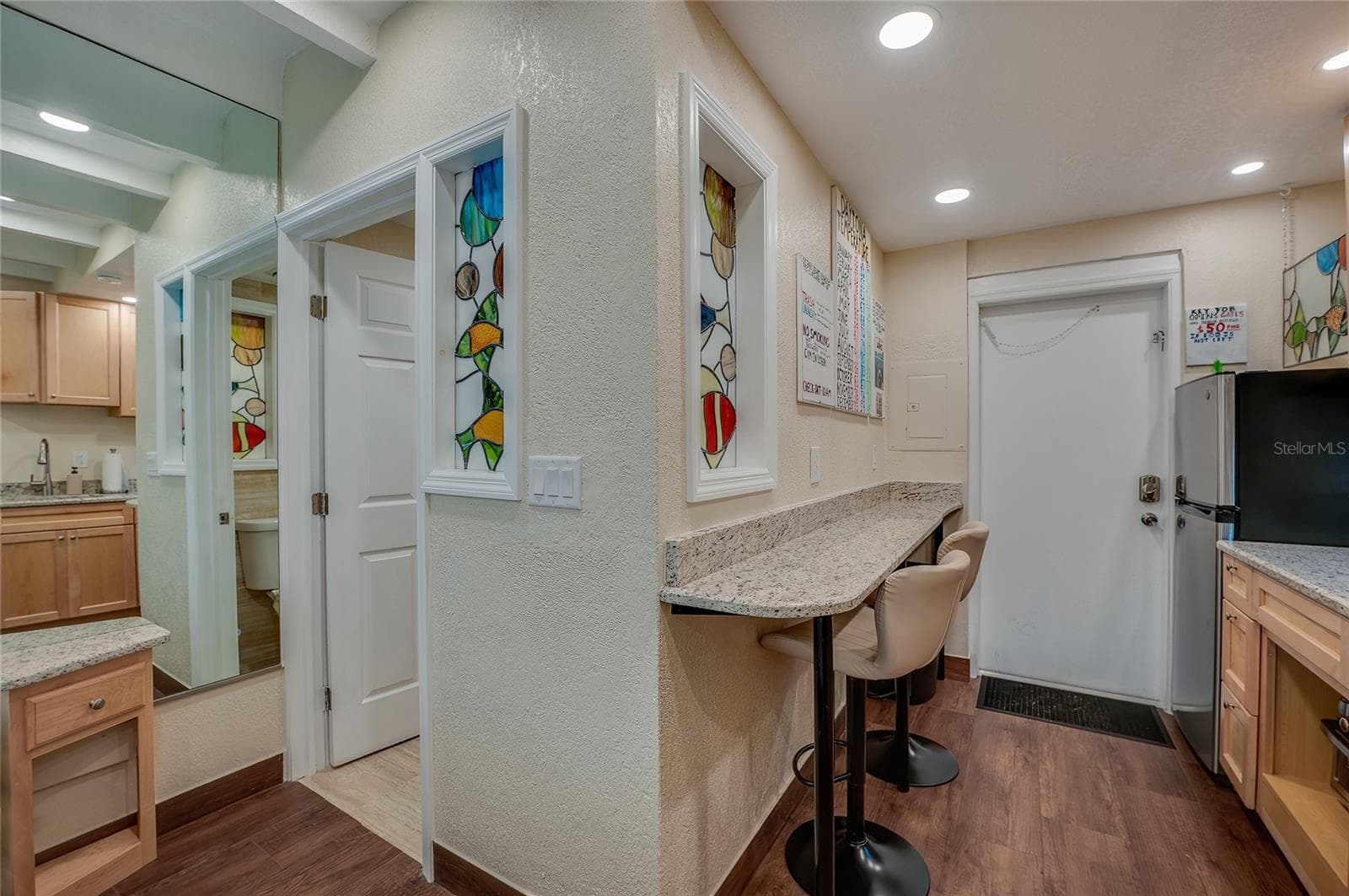 A convenient built-in bar area with seating offering a space-saving dining solution that's perfect for a quick breakfast or a casual meal. - 935 S ATLANTIC AVE #165, DAYTONA BEACH