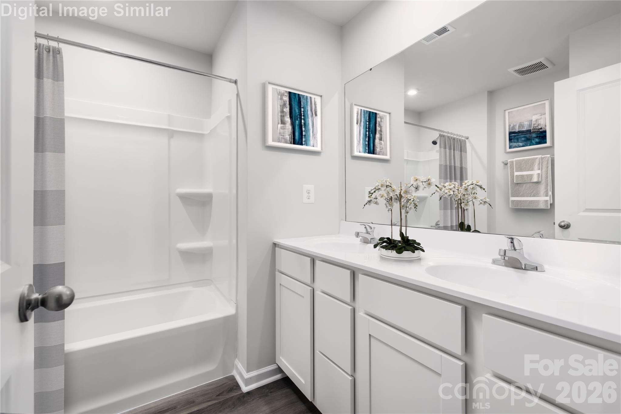 Soak, unwind, and get ready in style! This spa-inspired bath features a relaxing tub, dual vanities, and tons of storage — your daily escape starts here! - 4142 Vallhorn Lane, Charlotte