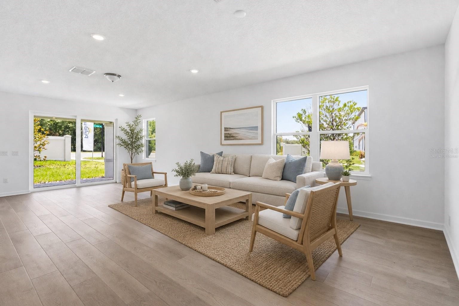 Virtually staged living space with warm wood look floors and an easy open layout. - 13824 SUNLIGHT MEADOW DR, RIVERVIEW