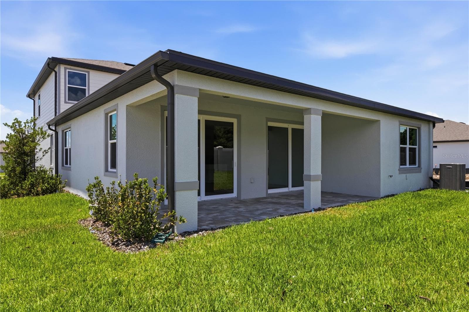Covered rear lanai and backyard space for grilling, relaxing, and easy Florida evenings. - 13824 SUNLIGHT MEADOW DR, RIVERVIEW