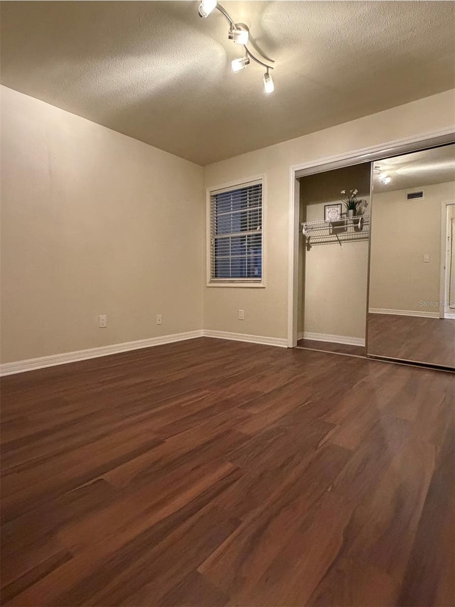 The second bedroom is 11x11 and has a large closet with full-length mirror doors. - 3815 N OAK DR #G71, TAMPA