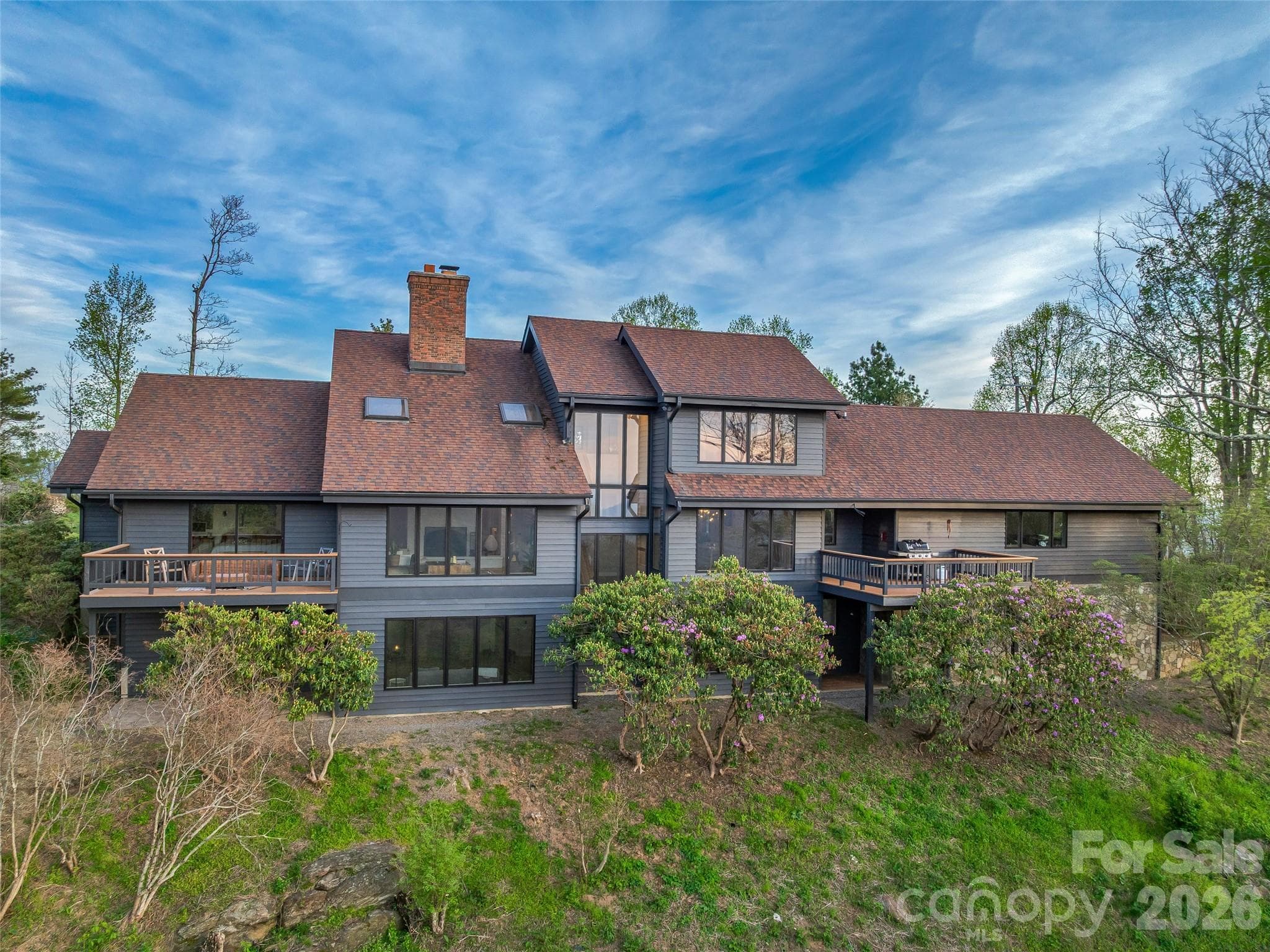 Recent exterior updates include cedar siding repainted in 2023, architectural shingle roof replaced in 2023 and decks refinished in 2026. - 100 Big Spring Drive, Asheville