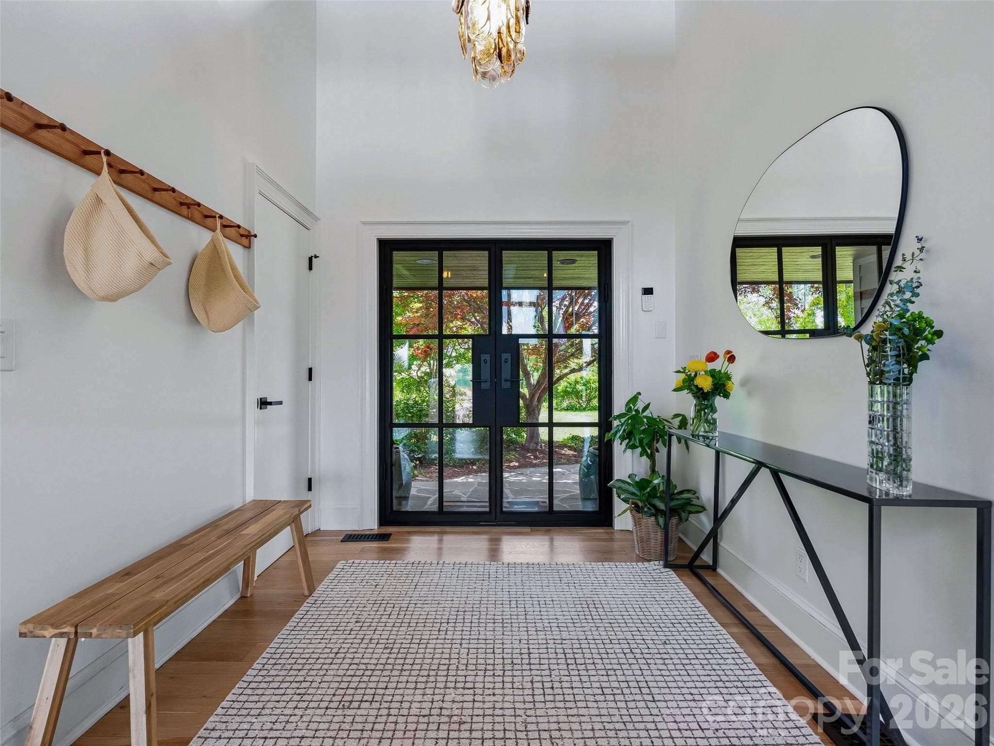 The foyer sets an elegant tone with two-story ceilings and an original Murano Italian vintage glass chandelier. - 100 Big Spring Drive, Asheville