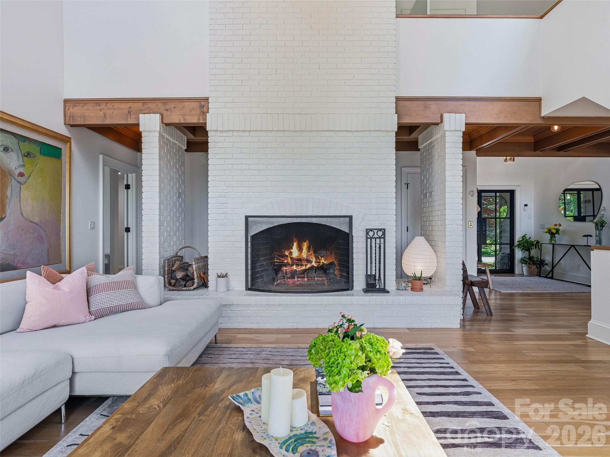 The floor to ceiling wood burning fireplace with wood storage niches makes for a dramatic focal point and adds rustic appeal. - 100 Big Spring Drive, Asheville