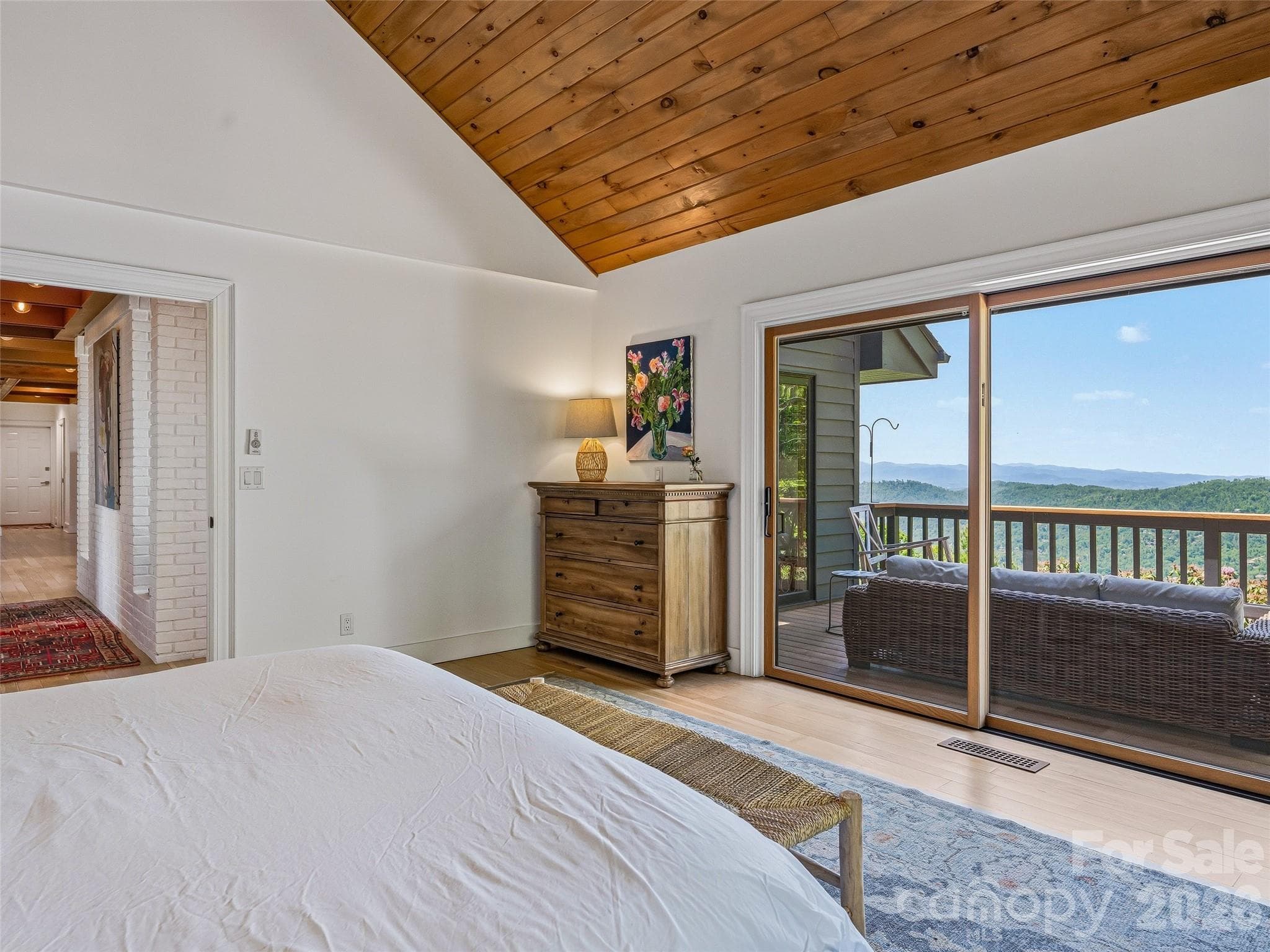 The primary suite offers seamless indoor/outdoor living. - 100 Big Spring Drive, Asheville