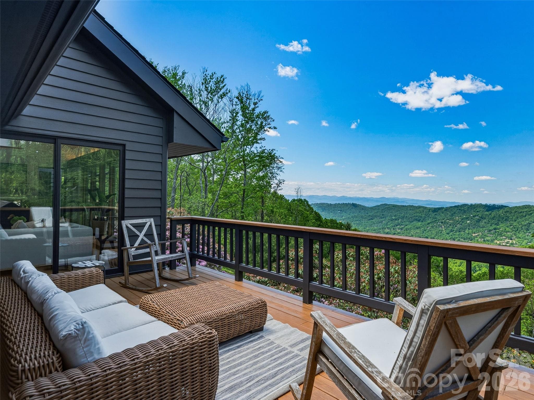 Enjoy sliding door access from both the primary suite and the great room. - 100 Big Spring Drive, Asheville