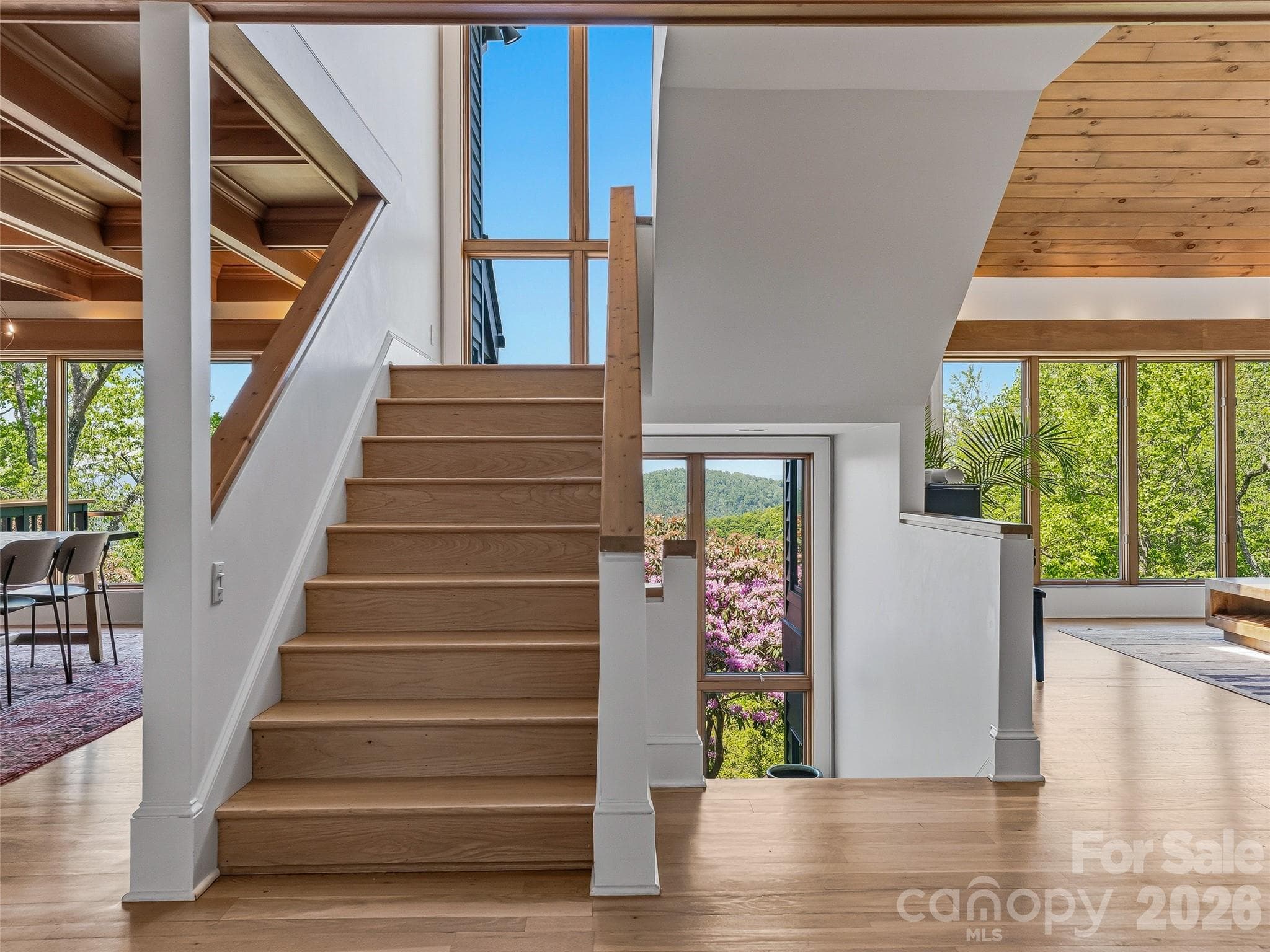 White oak flooring flows into every room and every level, accessed by the bright, airy stairwell. - 100 Big Spring Drive, Asheville