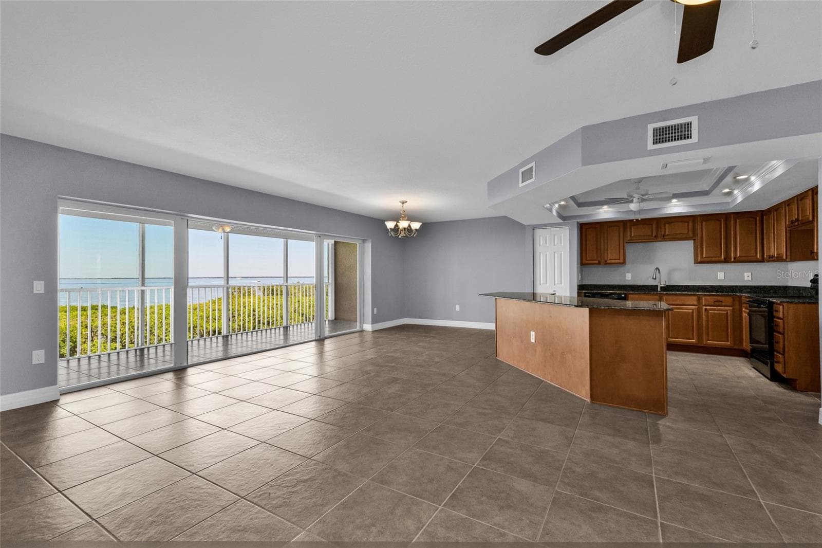 Living room overlooking Charlotte Harbor to the west - 101 N MARION CT #213, PUNTA GORDA