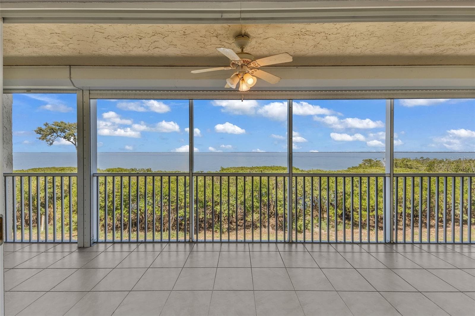 Living room overlooking Charlotte Harbor to the west - 101 N MARION CT #213, PUNTA GORDA