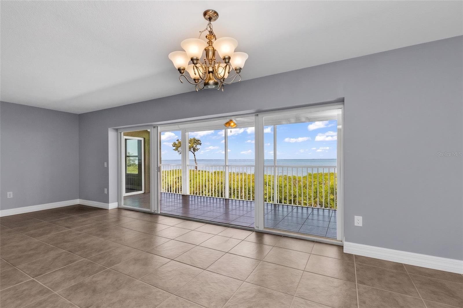 Living room overlooking Charlotte Harbor to the west - 101 N MARION CT #213, PUNTA GORDA