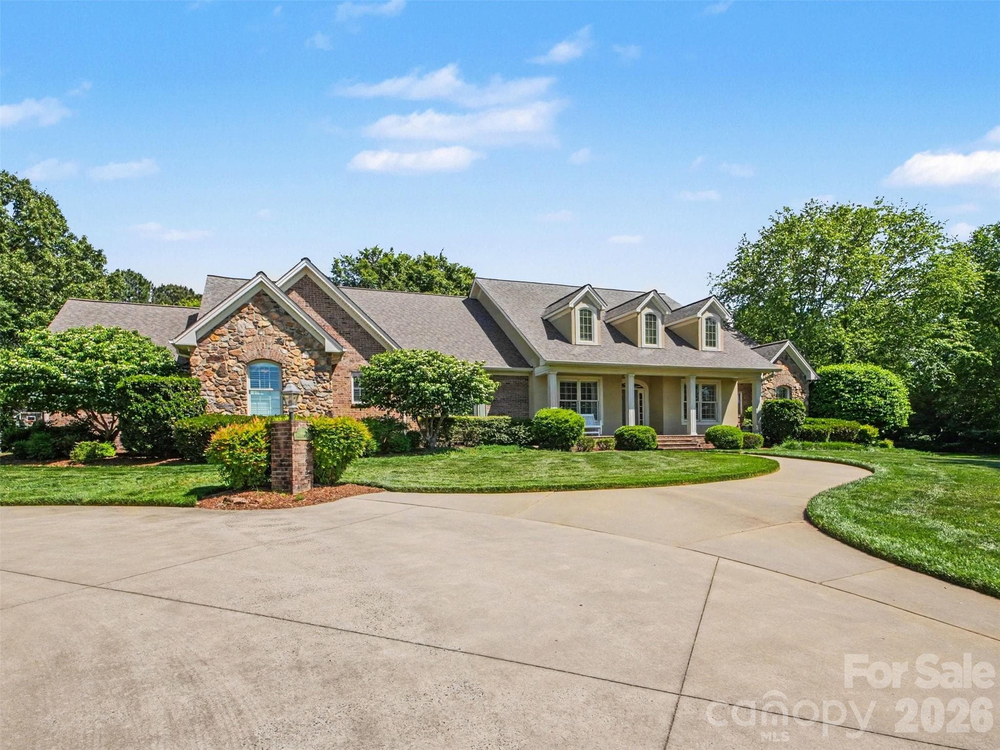 French provincial architecture with brick and stone accents on a level 1.75 acre private lot... - Shelby