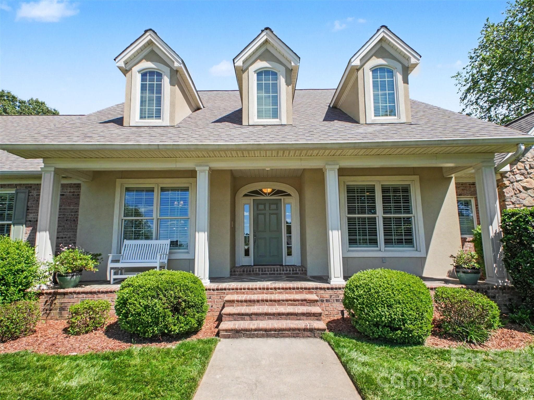 A large covered porch and pristine landscaping greet you. Sellers added landscape lighting for ambiance at night. - Shelby