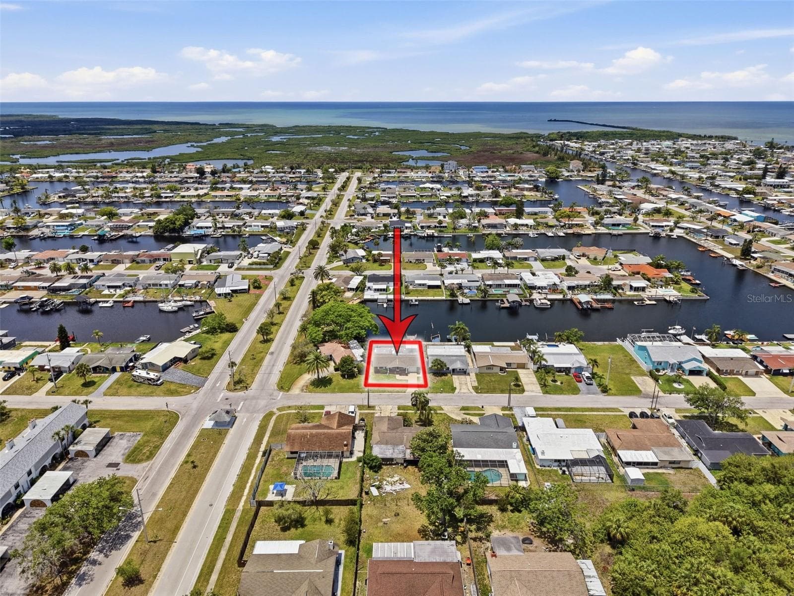 Aerial perspective highlights nearby canals and Gulf access. - 12735 1ST ISLE, HUDSON