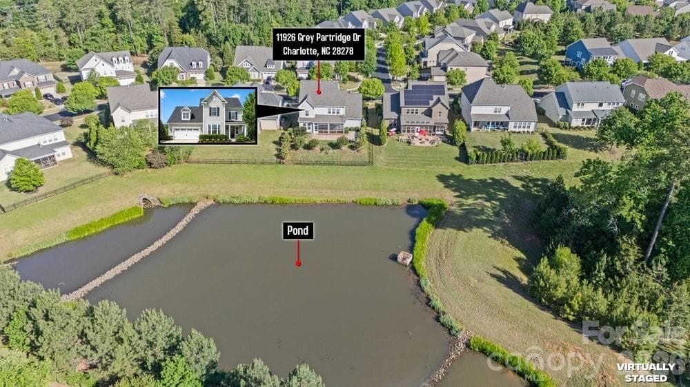 drone view of pond and neighborhood - 11926 Grey Partridge Drive, Charlotte