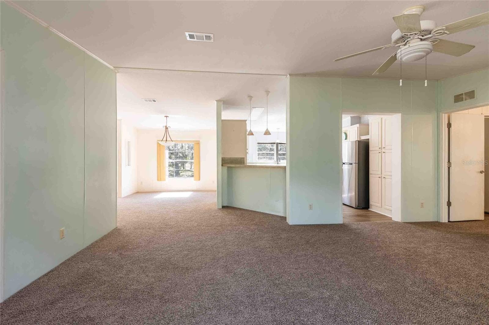 View from slider into kitchen and dining area. - 14221 HURRICANE DR, WEEKI WACHEE