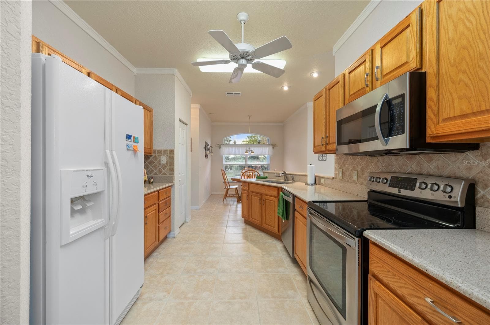 The kitchen features Silestone counters, lower cabinet pull-outs - 1637 PALACE CT, PORT CHARLOTTE