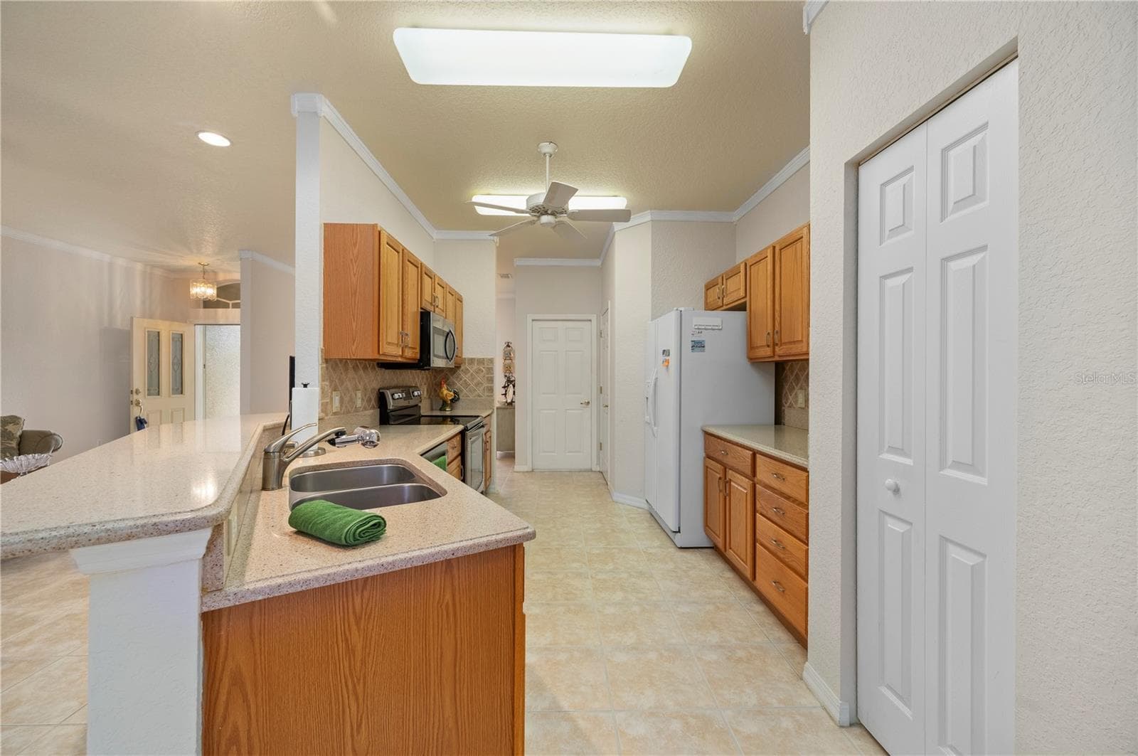Kitchen crown molding, access to garage and laundry - 1637 PALACE CT, PORT CHARLOTTE