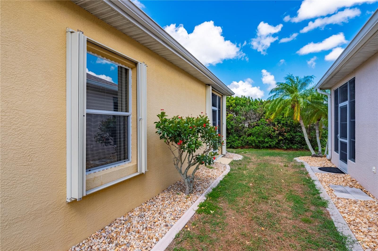 Accordian storm shutters on windows - 1637 PALACE CT, PORT CHARLOTTE